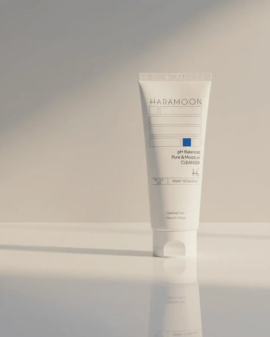 Tube of HaraMoon skincare product on a reflective surface with a neutral background